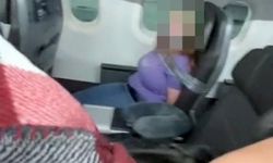 Uçağın kapısını açmaya çalışan kadını, koli bandıyla bağladılar